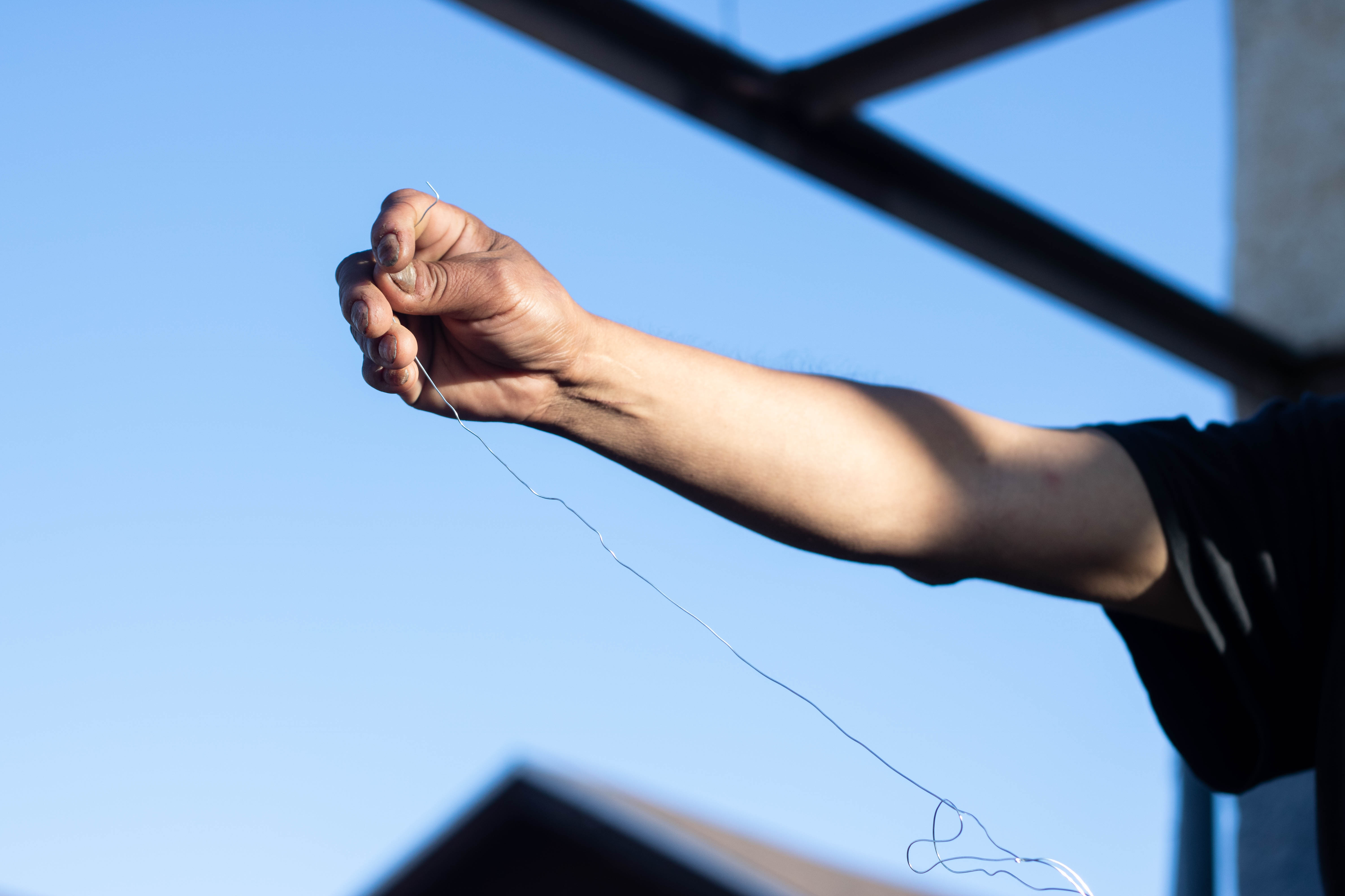 a hand holds fishing wire